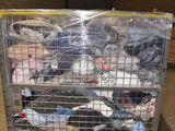 a metal cart with a lot of clothes inside of it