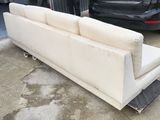 a couch that is sitting on a dolly in a garage
