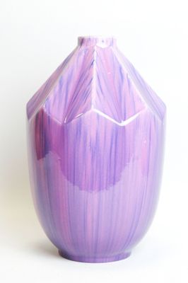 purple vase on a white surface with a white background