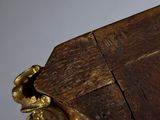 a wooden table with a gold vase on it