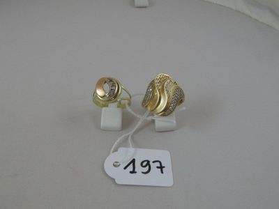 pair of gold and diamond earrings with price tag on white surface