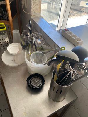 several kitchen utensils are sitting on a counter in front of a window