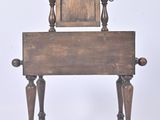 a small wooden bench with a mirror on it
