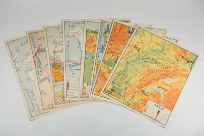 six cartes du monde sont disposées sur une table