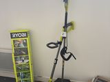 a picture of a green and black lawn mower next to a box of tools