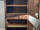 a wooden cabinet with a mirror on top of it