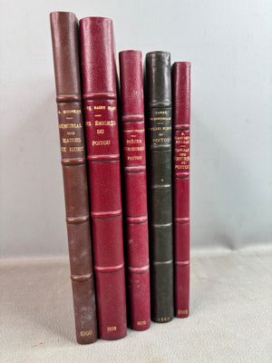 several books are lined up in a row on a table