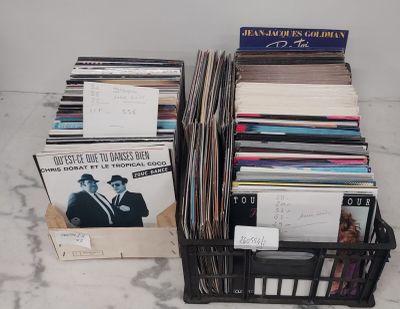 a lot of records in a black basket on the floor