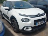 a picture of a white citrole parked in a parking lot