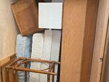 a small room with a bed and a chair in it