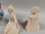 two figurines that are sitting next to each other