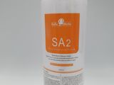 a close up of a bottle of soap on a white surface