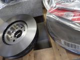 a close up of a brake disc on a wooden pallet