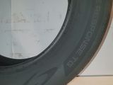 a close up of a tire on a white surface with a white wall in the background