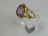 an image of a gold ring with an amethorate stone in it