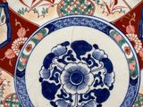 a plate with a design of flowers and birds on it