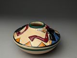 a small bowl with a design on it on a table