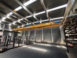 an industrial warehouse with a crane in the middle of the room