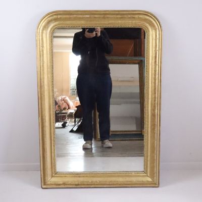 a woman taking a picture of herself in a mirror