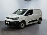 the white van is parked in a white room with a black floor