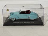 a blue toy car in a clear case on a table