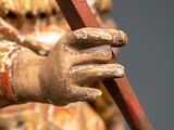 a statue of a man holding a stick in his hand