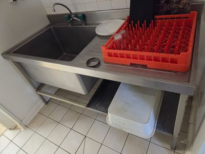a sink with a bunch of red cups in it