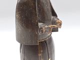 an old wooden statue of a man with a hat and a cane