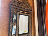 a mirror on the wall next to a mirror on the wall