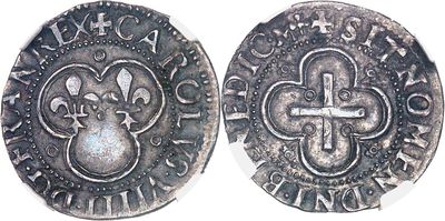 a close up of a coin with a cross on it