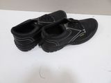 a pair of black shoes that are on a table