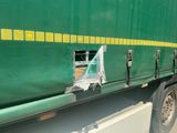 a green truck with a yellow stripe on the side of it