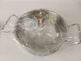 a silver bowl with a spoon in it sitting on a table