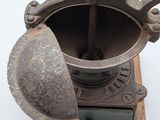 an old machine that is sitting on top of a wooden stand
