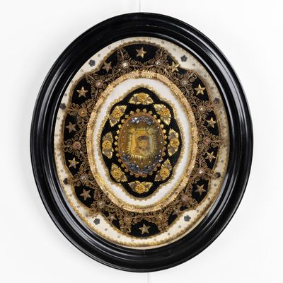 a black and gold clock with a face in the center