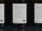 three bottles of wine sitting on top of a table next to each other