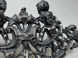 a silver brooch that has two cherenshes on it