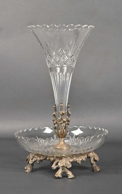 a glass vase on a stand on a gray background