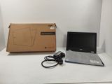 a laptop computer sitting on a table next to a box