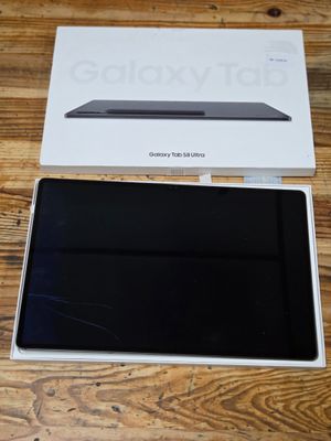 the box is open on a wooden table with a laptop in it