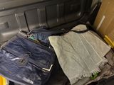 a suitcase full of clothes and a bag in the trunk