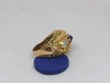 a close up of a gold ring with a lion head on it