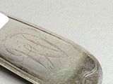 a silver knife with a white handle on a table