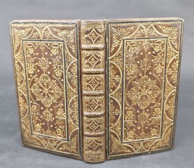 a close up of a book on a table with a gray background