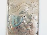 a silver plaque with a picture of a woman holding a child