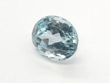 a close up of a blue topazte stone on a white surface