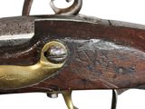 a close up of a rifle with a brass plated handle