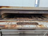an old oven with a rusted surface in a kitchen