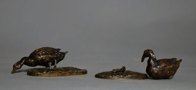 trois figurines en bronze représentant des canards empilés les uns sur les autres