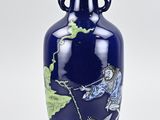 a blue vase with a dragon on it sitting on a table